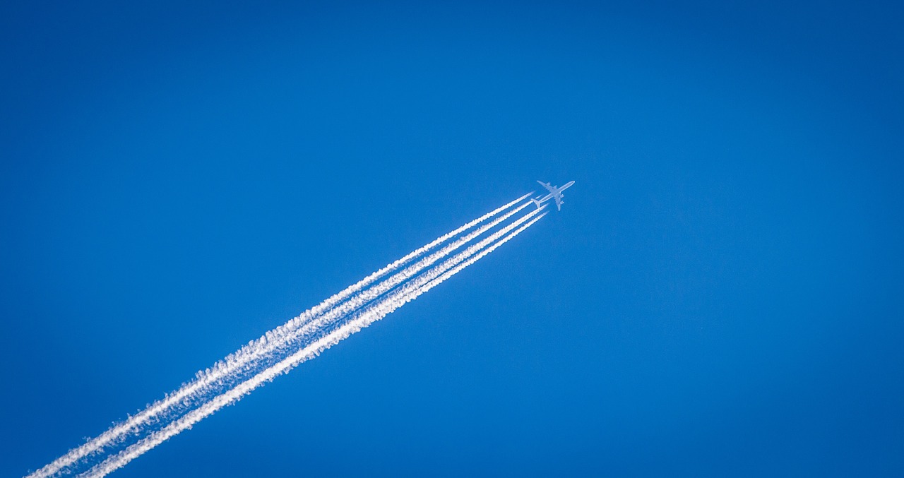 Aircraft in sky with lines behind 