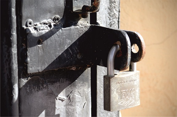 Metal padlock on a metal gate