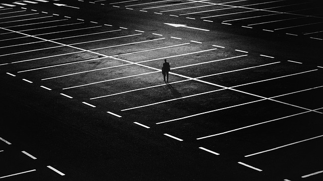 Person in empty parking lot