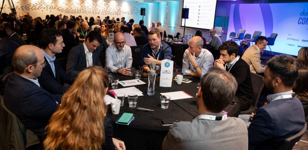 A group of data leaders chatting about framework at a rondtable.
