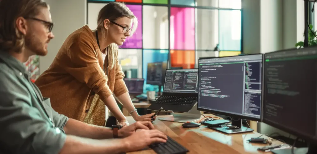 Two people working on data tech machine learning tools.