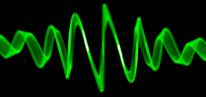 Bright green soundwave against a black background