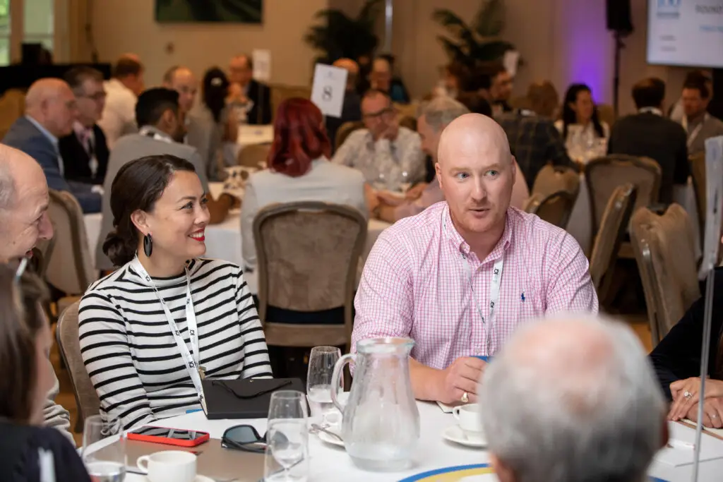 Two data leaders, a woman and a man, at a roundtable discussing data culture at the DataIQ discussion event in 2022.