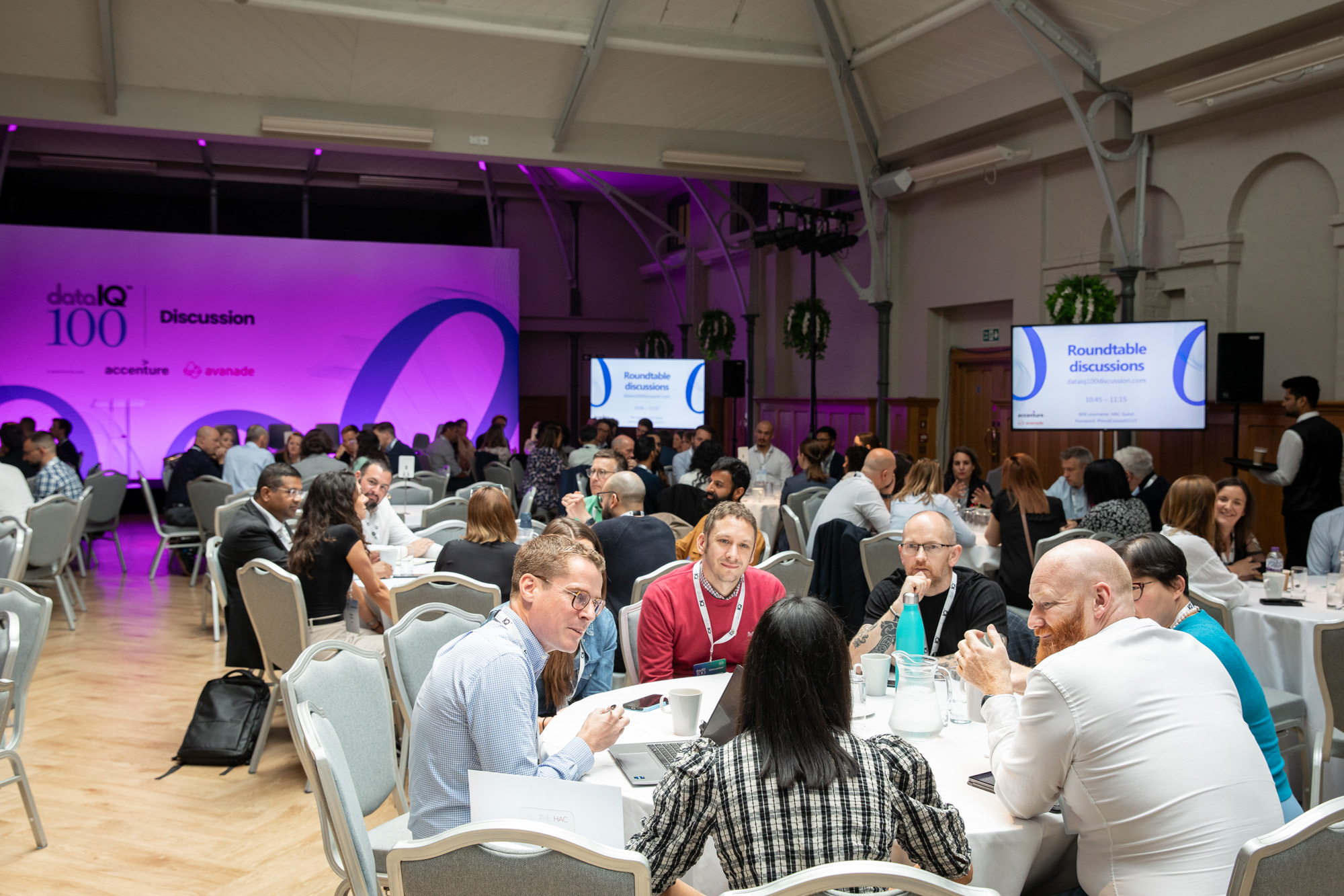 DataIQ members discussing priorities and financial aspects at a roundtable.