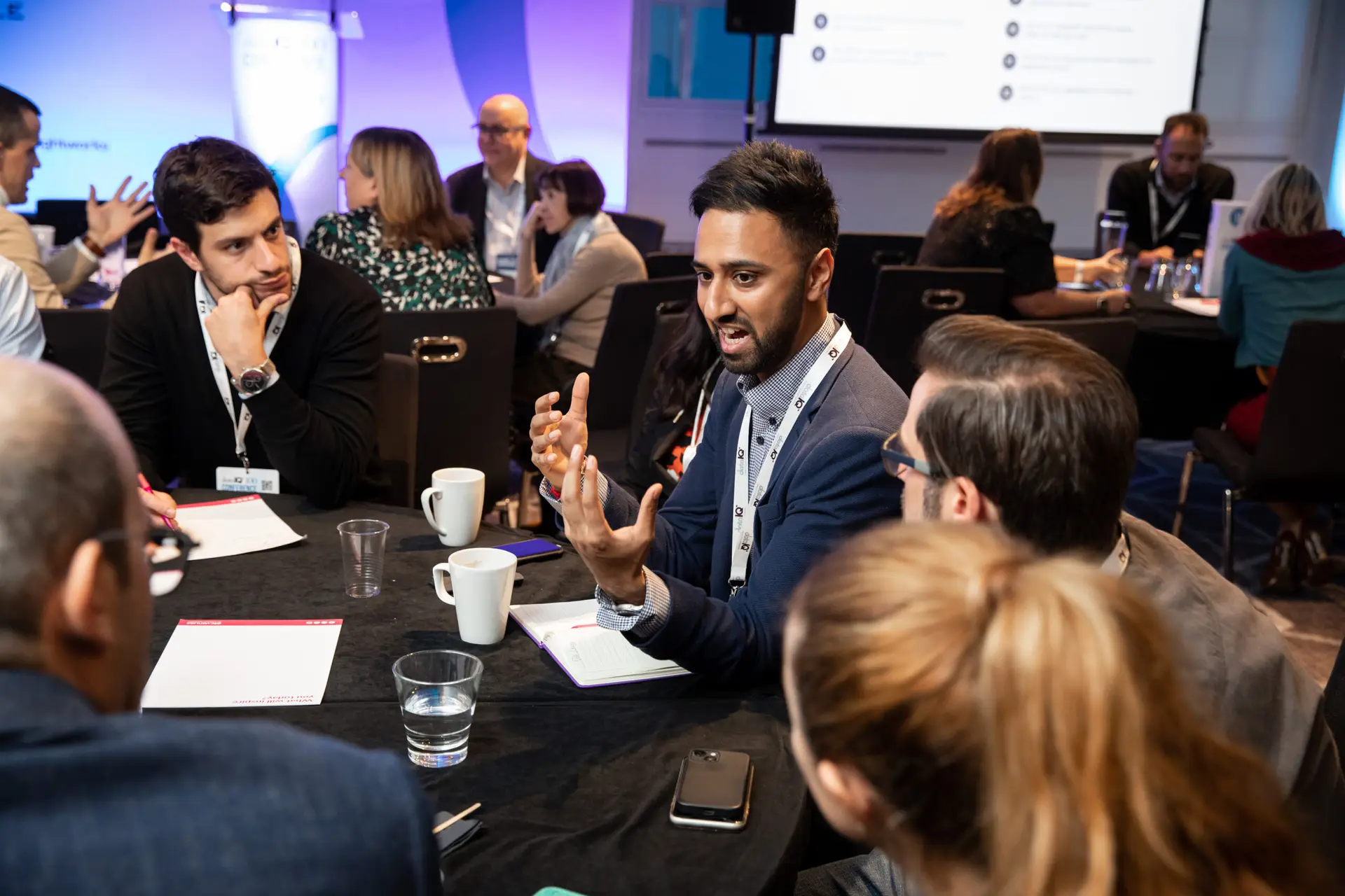 A group of people engaged at a roundtable discussion.