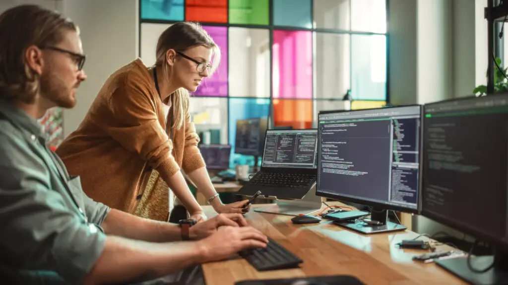Two people working on data tech machine learning tools.